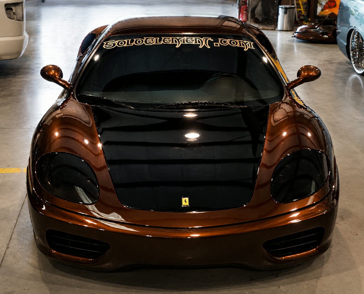 Candy brown Ferrari 360 Modena, front view, with a black hood